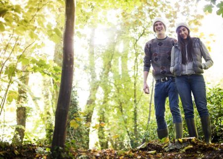 A young, happy couple hiking in the woods