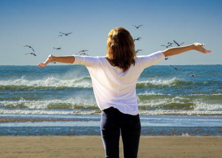 A woman enjoying the beach without pain