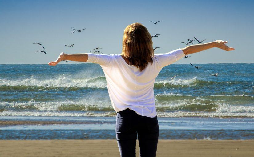 A woman enjoying the beach without pain