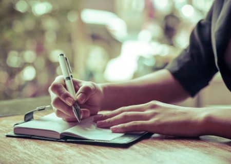 woman writing in pain journal