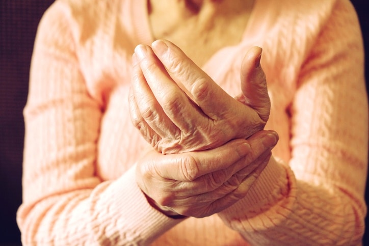 A woman rubbing the arthritis in her hand